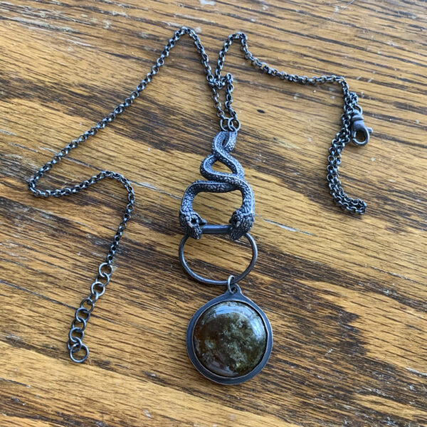 silver intertwining snakes necklace